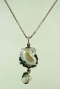 A pearl pendant with enamel leaf mount,