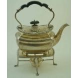 A George V silver oblong shaped and gadrooned tea kettle on four bun feet,