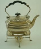 A George V silver oblong shaped and gadrooned tea kettle on four bun feet,