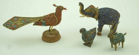 Four Indian figures of animals inset with coloured glass cabochons within gilt metal surrounds in
