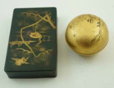 A rectangular tole box, painted in gilt with cranes in a river landscape on a green ground, 16.