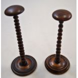 Two Victorian fruit wood wig stands with bobbin turned uprights,