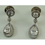 A pair of diamond drop earrings, the old brilliant cut fitting of approximately 0.