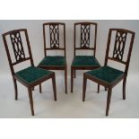 A set of four Edwardian mahogany and satinwood banded chairs with pierced splat,