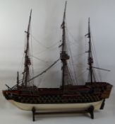 A scratch model of the Victory, with cannons presented, on ebonised stands, 100cm high,