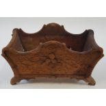 A Black Forest carved planter of shaped rectangular form with flared feet, 21cm high, 34cm wide, 14.
