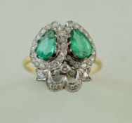 An emerald and diamond lovers hearts ring, the diamonds totalling approximately 1.