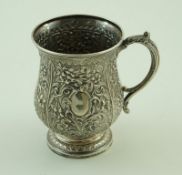 A Victorian silver baluster christening mug, profusely embossed with foliate scrolls,