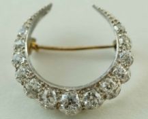 A late Victorian diamond set crescent brooch,