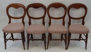 A set of four Victorian beech balloon back chairs with stuff over seats linked by stretchers