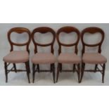 A set of four Victorian beech balloon back chairs with stuff over seats linked by stretchers