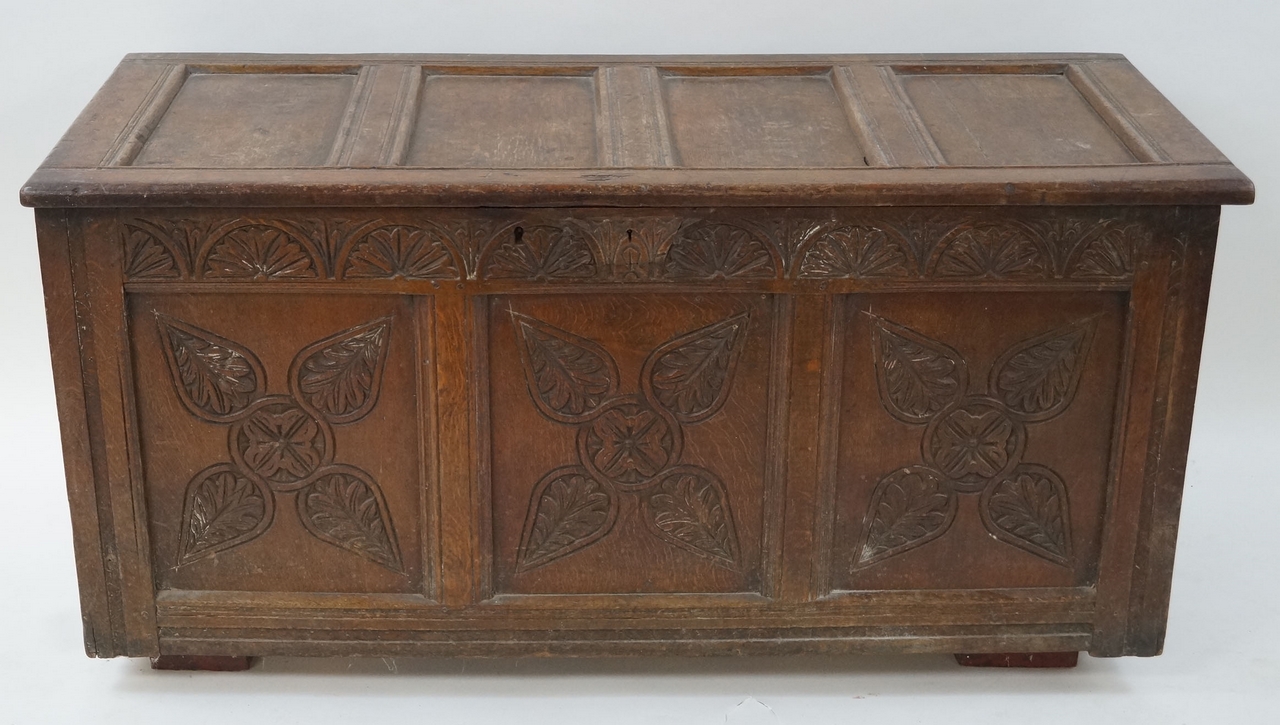 A 17th century oak panelled coffer, with quadruple carved panel front, and carved frieze, 66cm high,
