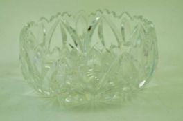 A round glass bowl cut with stylised flowers,