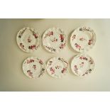 A set of fourteen 19th century English porcelain dessert plates each of scalloped form painted with