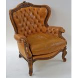 A walnut show frame armchair with leather button back and loose cushion on cabriole legs