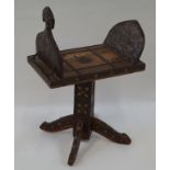 A middle Eastern stool, overlaid with embossed metal mounts on square pedestal and four flared feet,
