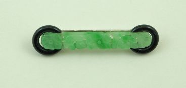 A carved jade and black onyx panel brooch,