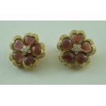 A pair of carved garnet and diamond flower shaped clip earrings,