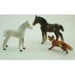 A Beswick figure of a fox, printed factory marks in black and paper label 6cm high,