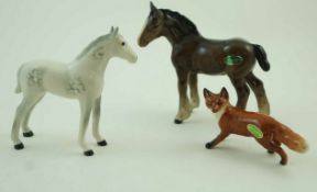A Beswick figure of a fox, printed factory marks in black and paper label 6cm high,