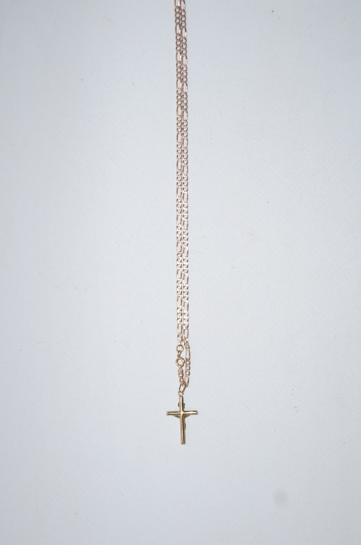 A crucifix pendant, on a figaro link chain, stamped '375', 59cm long, 7.