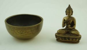 An Indian polished bronze of god, 11cm high together with a brass bowl,