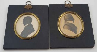 An early 19th century silhouette of a gentleman facing left in black papier mache frame and another