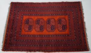 A rug with four cantered rectangular medallions on a red field within multiple wide borders,