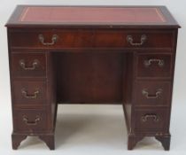 A mahogany knee hole desk with leather inset top,
