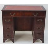 A mahogany knee hole desk with leather inset top,