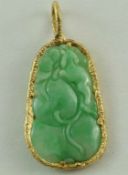 A carved jade pendant within a textured gold rim mount, carved as peaches, 5.
