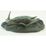 A patinated bronze figure of a crab on a rocky base with a fish and a shell, by W.H.