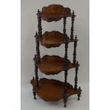 A Victorian walnut waterfall whatnot with barley twist supports and decorative marquetry panels to