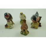 A collection of four Beswick birds, comprising of a Goldfinch, a wren model number 993,