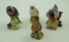 A collection of four Beswick birds, comprising of a Goldfinch, a wren model number 993,
