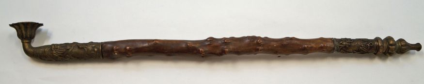 A Chinese decorative hardwood smoking pipe with a brass metal mount decorated with dragons 95cm