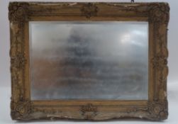 A wall mirror in Victorian gilded gesso frame,