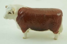 A Beswick figure of a Hereford bull, printed factory marks in black and painted “Ch of Champions”,