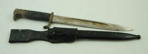 A German dress bayonet with blade engraved W K & C with a black chequered grip, 35.
