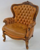 A walnut show frame armchair with leather button back and loose cushion on cabriole legs