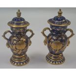A pair of Masons ironstone vases and covers, each decorated in gilt on a blue ground, circa 1815,