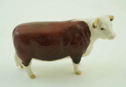 A Beswick figure of a Hereford cow, printed factory marks in black and painted “Ch of Champions”.