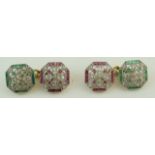 A pair of diamond and calibre ruby and emerald cufflinks, the openwork square cut corner panels, 12.