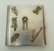 A Russian silver cigarette case decorated with various symbols to the cover,