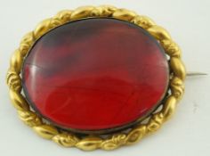 A Victorian oval red amber brooch,