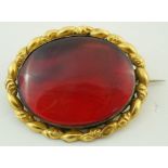 A Victorian oval red amber brooch,