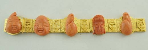 A continental bracelet set with carved coral oriental faces,