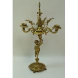 A gilt metal candlebrum with four scrolling arms,