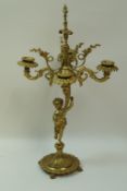 A gilt metal candlebrum with four scrolling arms,