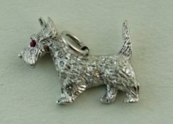 A diamond set Scottish Terrier pendant charm, set with single cut diamonds and a ruby eye, 2cm long,